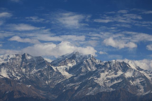 Rugged snow peaks under dramatic clouds