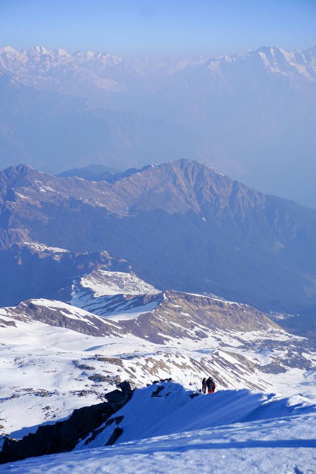 Snowy ridgeline and valley in blue haze