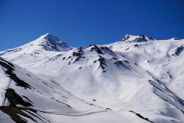 Snow-covered peaks and a wide snow bowl