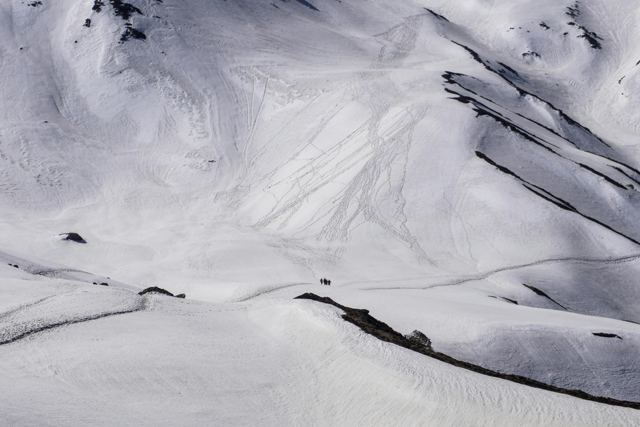 A wide, unbroken snow slope on a high Himalayan ridge